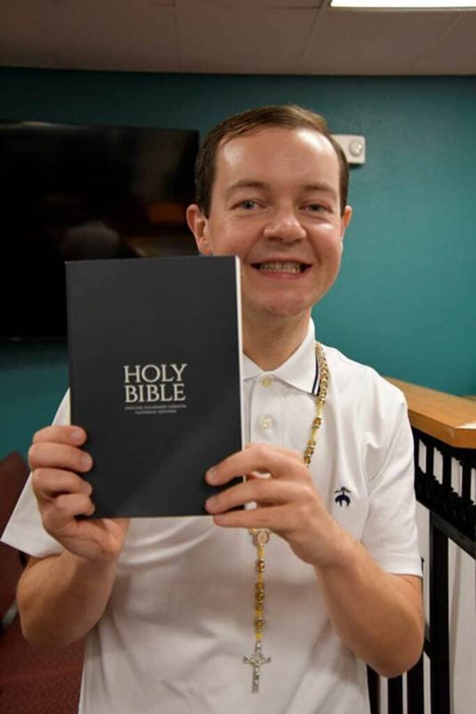 Adam Kotas with Holy Bible Book