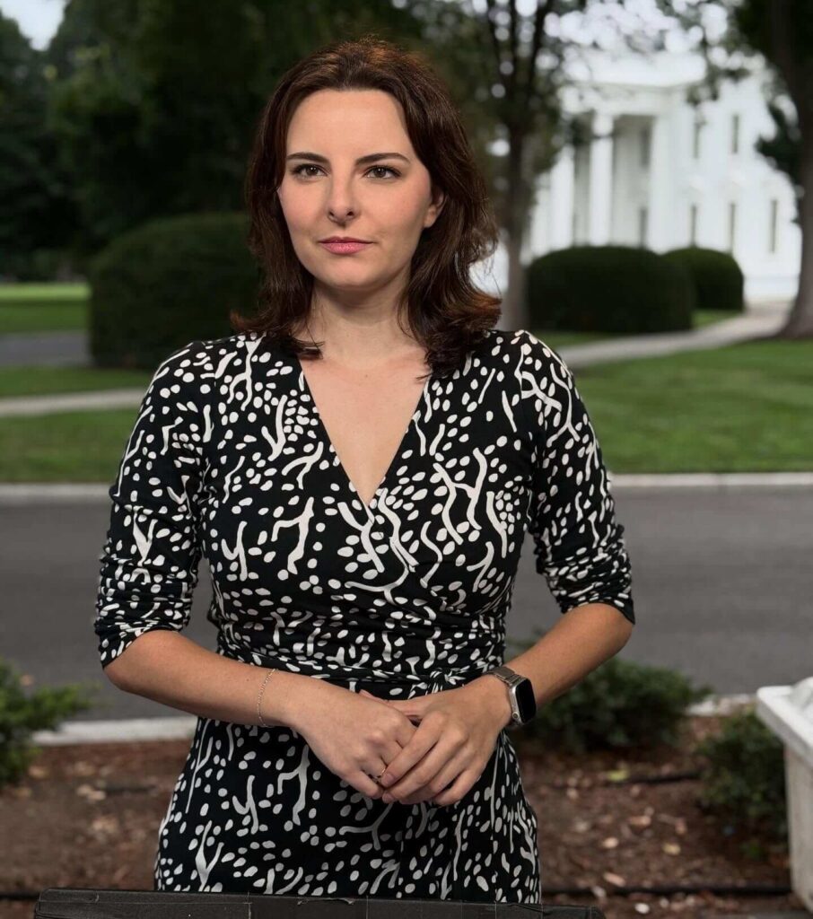 Caitrin Assaf standing front to the white house