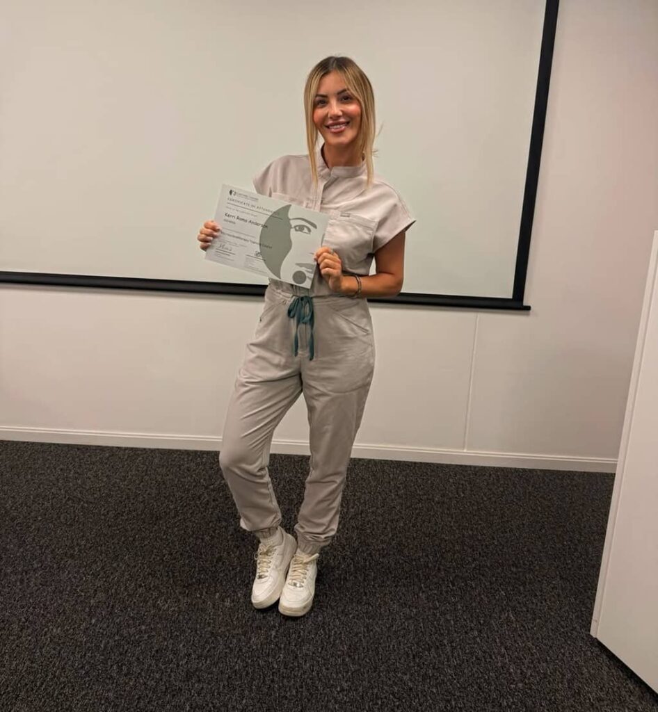 Kerri Roma with certificate of attendance