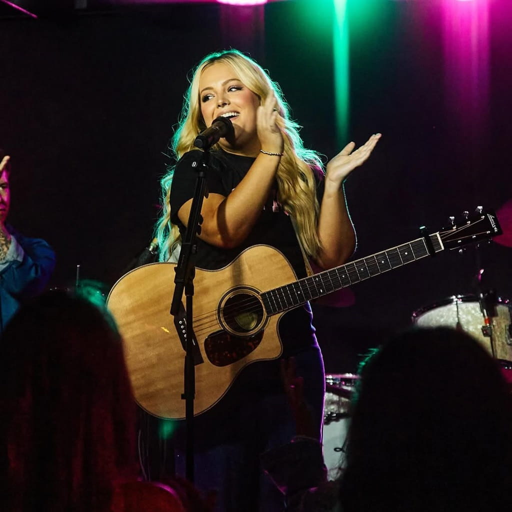 MaRynn Taylor playing guitar