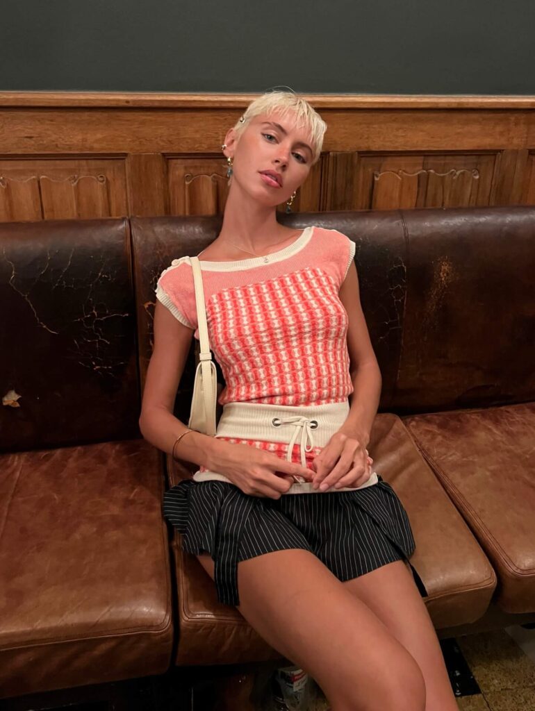 Iris Law sitting on sofa